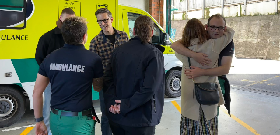 A group of people shake hands and hug